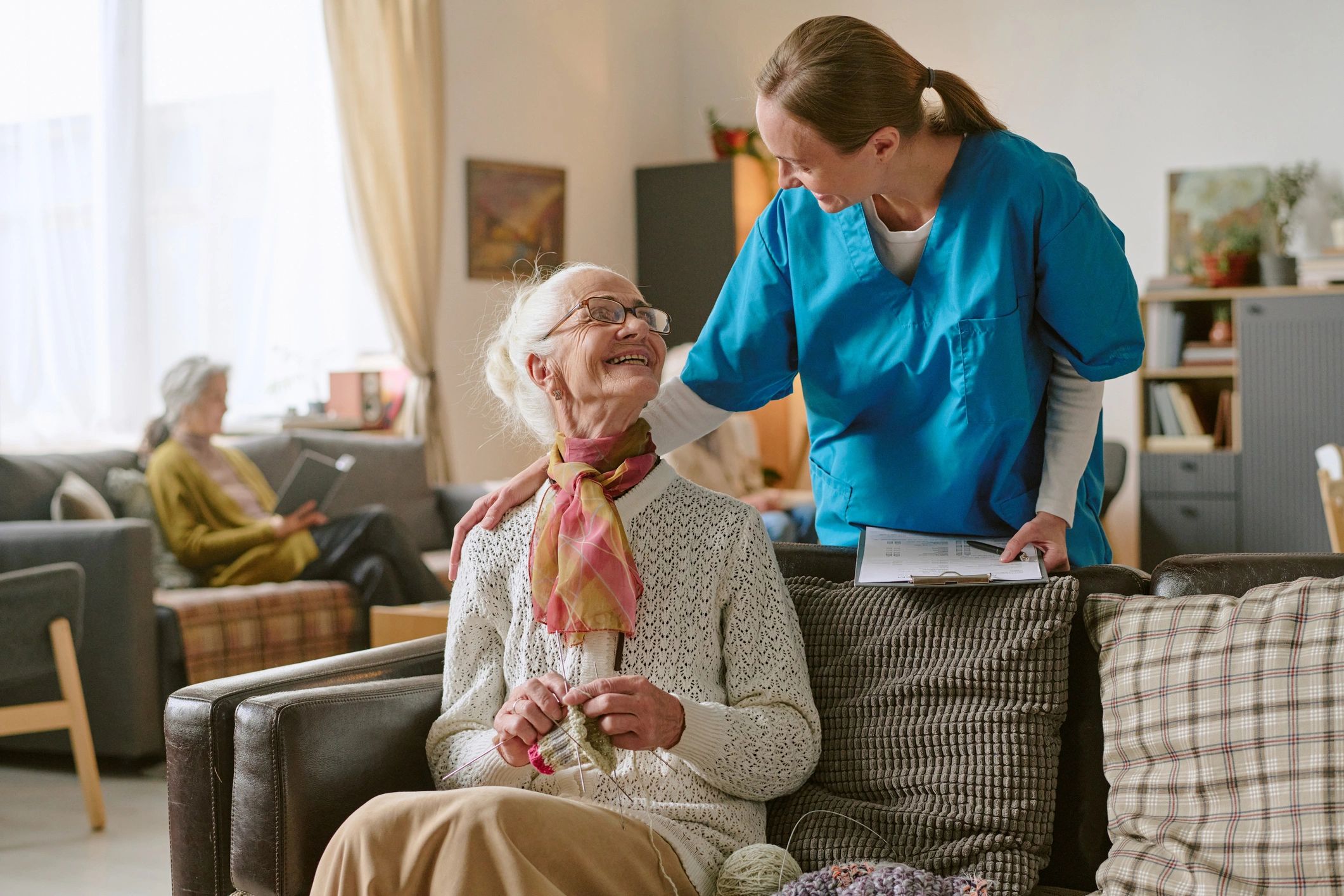Caregiver smiling with senior woman at home